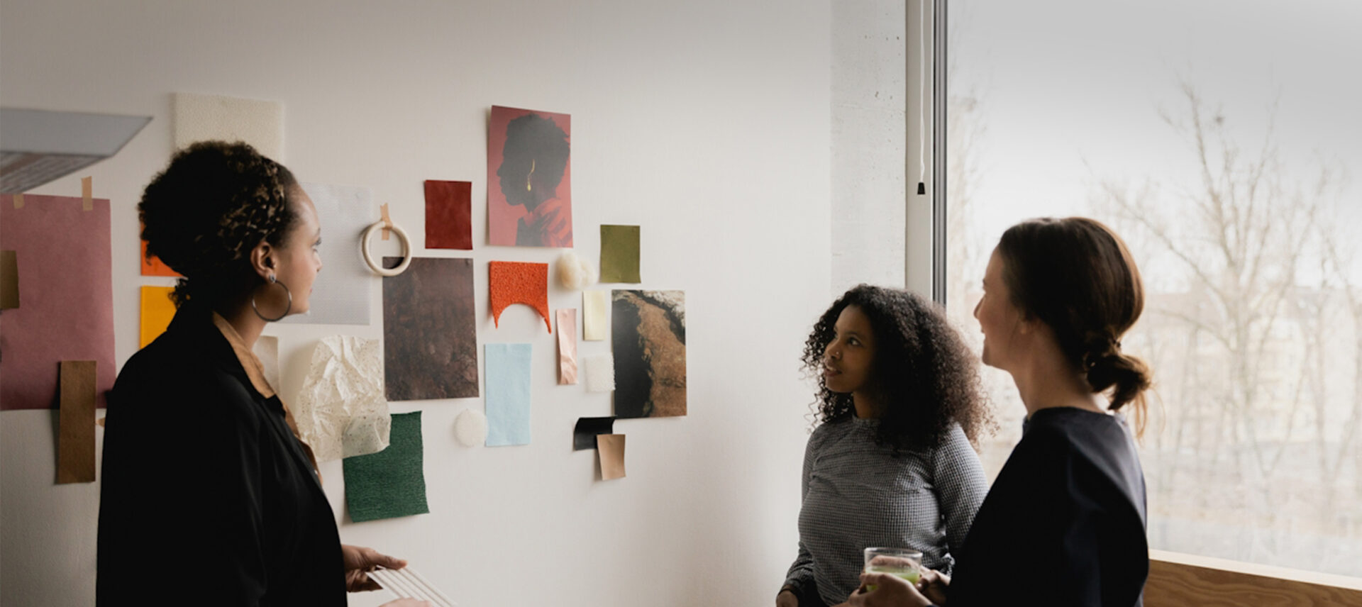 3 women looing at a mood board